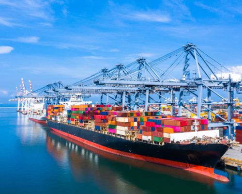 Container cargo ship at industrial port in import export business logistic and transportation of international by container cargo ship in the open sea.