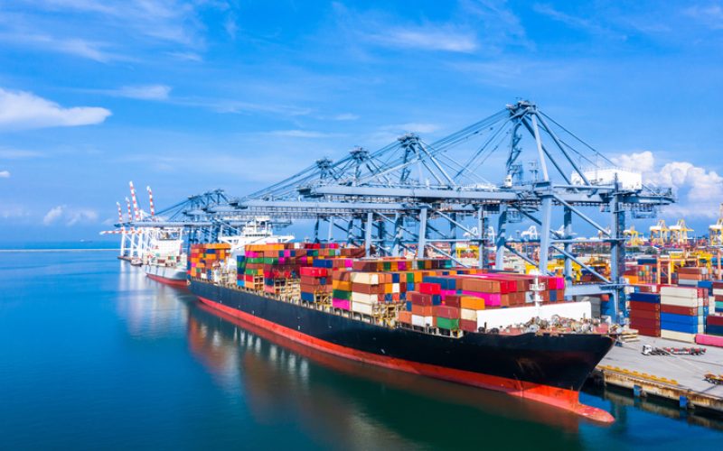 Container cargo ship at industrial port in import export business logistic and transportation of international by container cargo ship in the open sea.