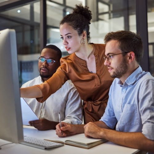 Learning, computer and training business interns in night office with manager, boss and leadership help. Men with technology planning ideas, kpi strategy and marketing innovation vision with mentor