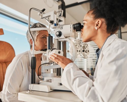 Senior eye exam, glaucoma specialist and medical eyes test of elderly woman at doctor consultation. Vision, healthcare focus and old female patient with consulting wellness expert for lens check