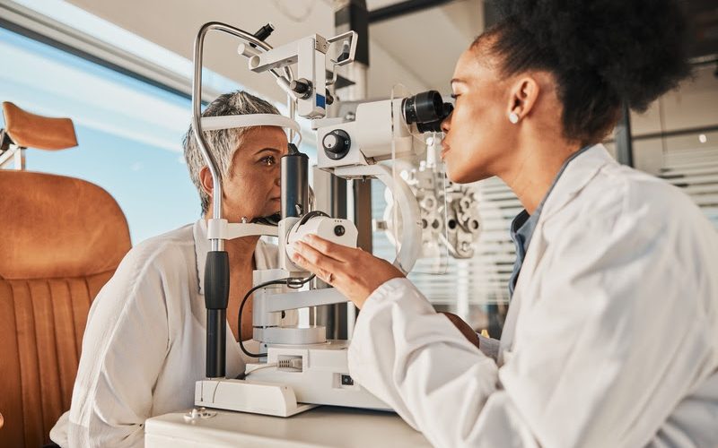 Senior eye exam, glaucoma specialist and medical eyes test of elderly woman at doctor consultation. Vision, healthcare focus and old female patient with consulting wellness expert for lens check